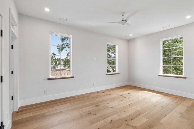 empty room with ceiling fan, baseboards, light wood-style flooring, and recessed lighting