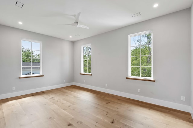 spare room featuring recessed lighting, baseboards, light wood-style floors, and a ceiling fan