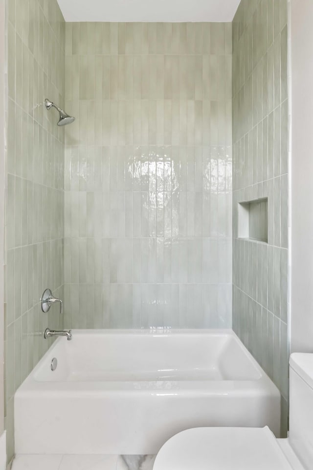 bathroom with toilet and shower / bath combination