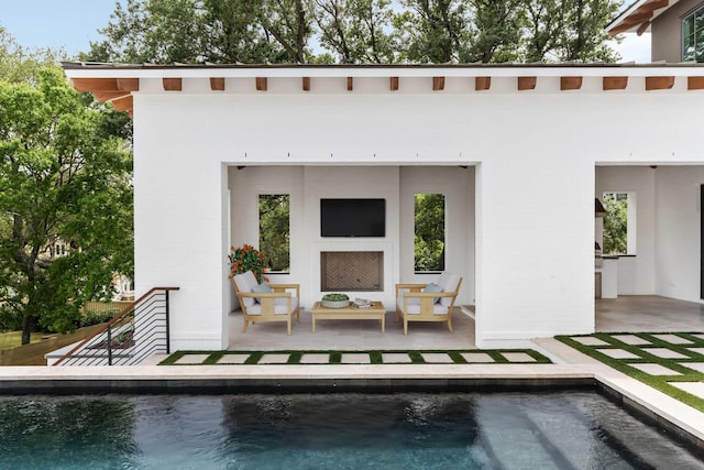 back of house with an outdoor pool, a patio, an outdoor hangout area, and brick siding