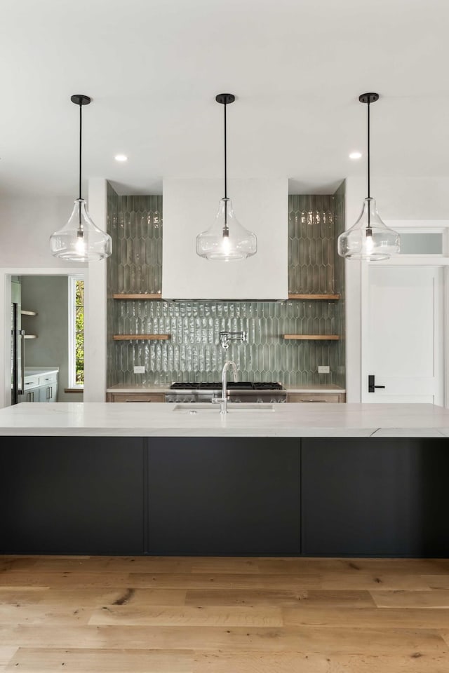kitchen featuring open shelves, decorative backsplash, light countertops, pendant lighting, and recessed lighting