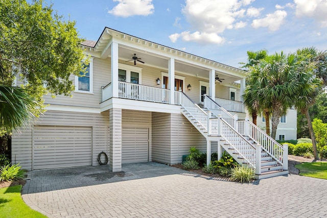 beach home featuring ceiling fan, covered porch, and a garage