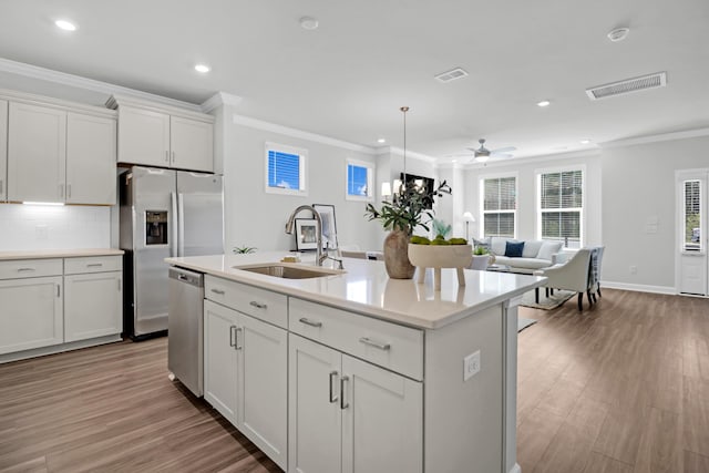 123 Brown Swiss Cir, Summerville, SC 29483 - kitchen with visible vents, recessed lighting, wood finished floors, a sink, and stainless steel appliances