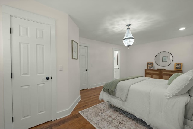 bedroom featuring dark wood finished floors and baseboards