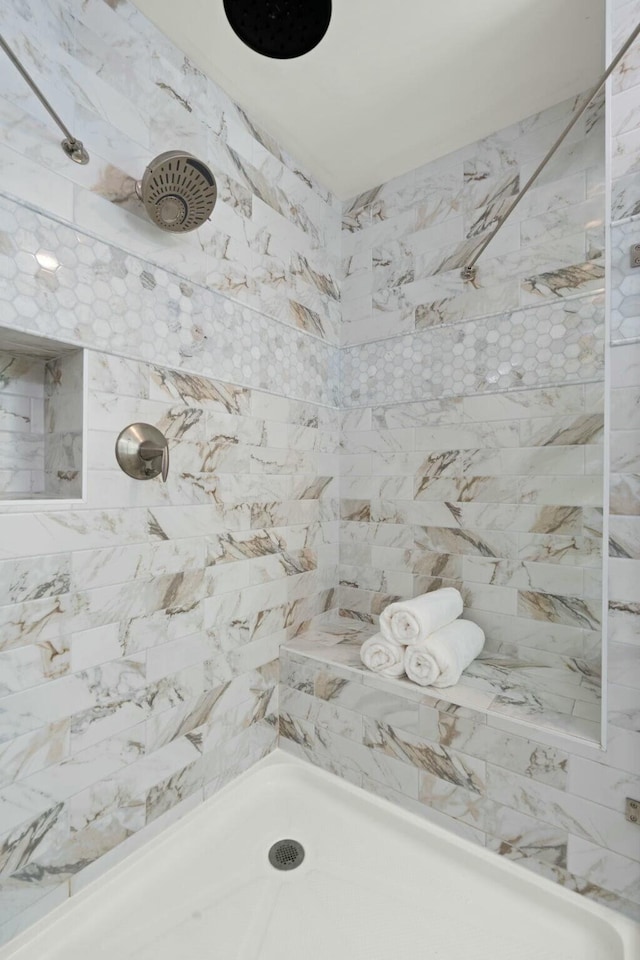 full bathroom with a tile shower