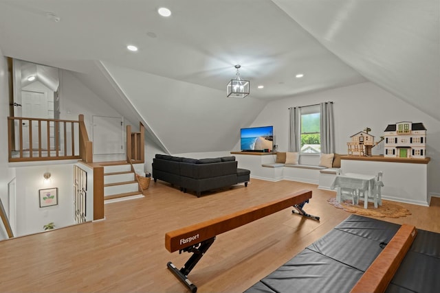 interior space featuring recessed lighting, vaulted ceiling, and wood finished floors