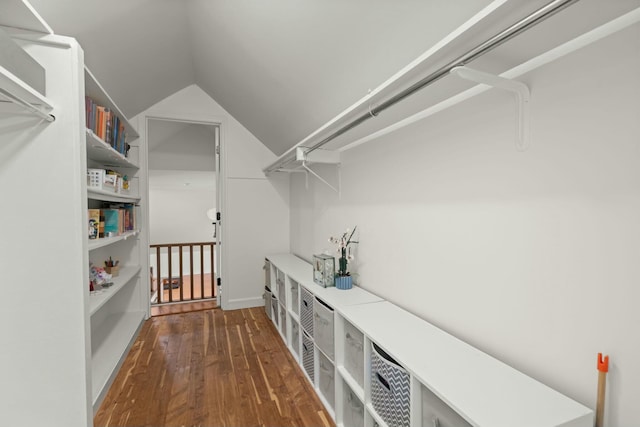 walk in closet with hardwood / wood-style flooring and lofted ceiling