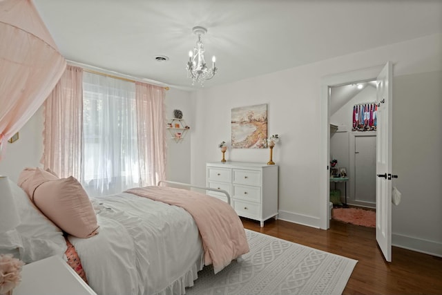 bedroom with dark wood finished floors, baseboards, a notable chandelier, and visible vents
