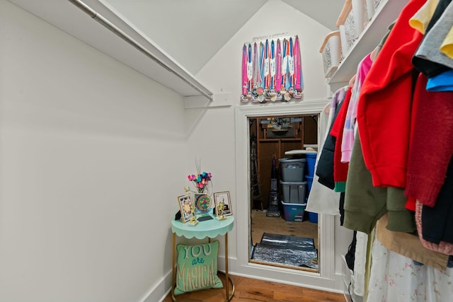 walk in closet featuring lofted ceiling and wood finished floors