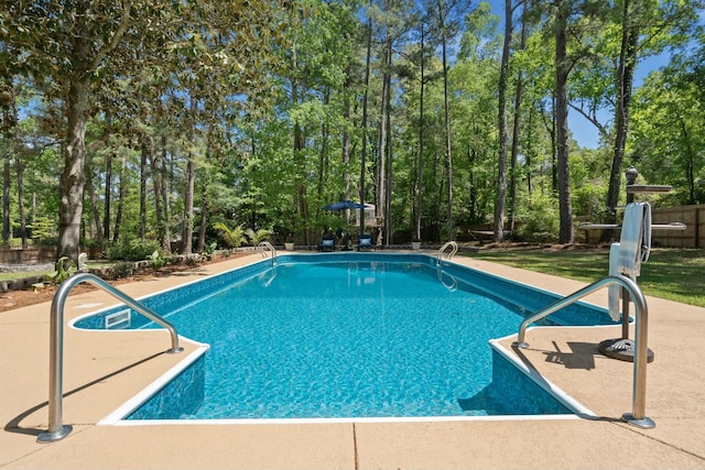 outdoor pool with a patio area