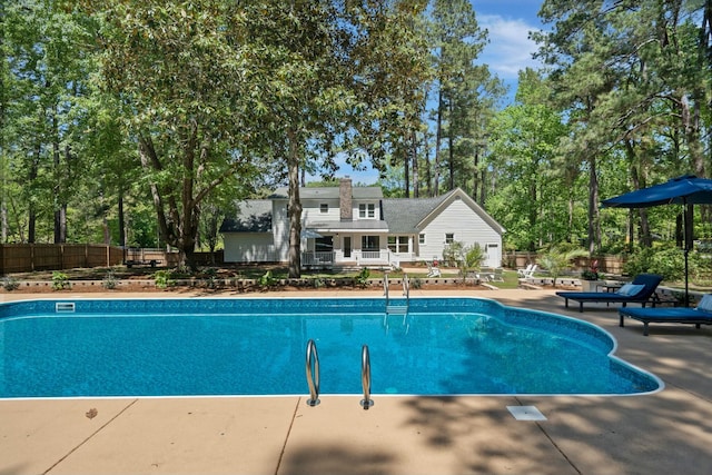view of pool with fence, a fenced in pool, and a patio