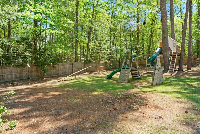 view of yard with fence and a playground
