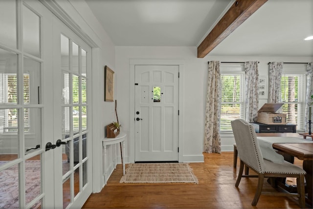 foyer with baseboards, french doors, and wood finished floors