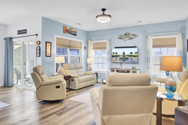 3473 Plow Ground Rd, Johns Island, SC 29455 - living area with wood finished floors, healthy amount of natural light, and baseboards