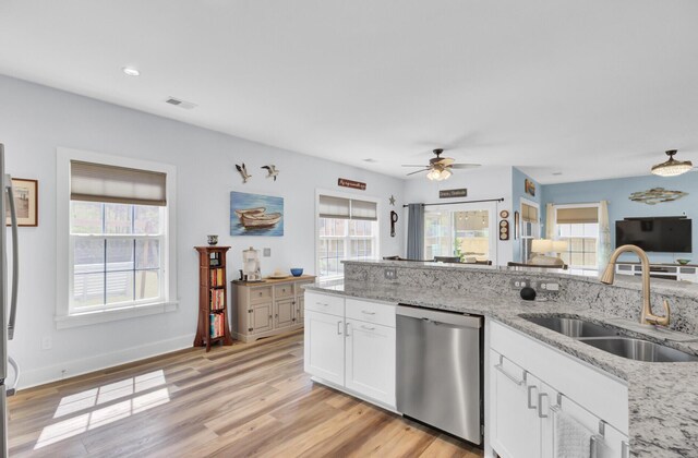 3473 Plow Ground Rd, Johns Island, SC 29455 - kitchen featuring stainless steel dishwasher, a sink, healthy amount of natural light, white cabinetry, and recessed lighting
