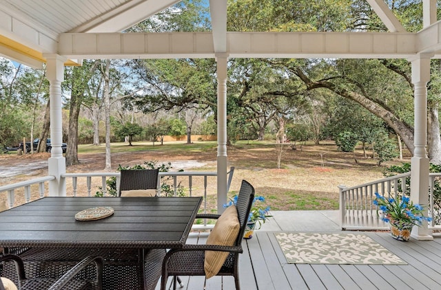 wooden terrace featuring outdoor dining space