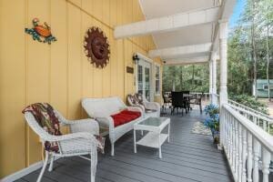 wooden terrace featuring outdoor dining area