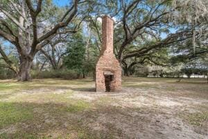 view of yard with a fireplace