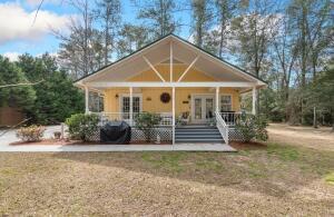 view of front facade with covered porch and french doors