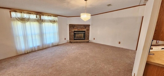 unfurnished living room with carpet flooring, crown molding, a fireplace, and a chandelier