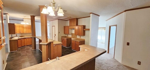 kitchen with a kitchen island, hanging light fixtures, a textured ceiling, and a notable chandelier