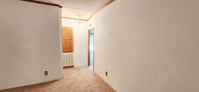 hall with lofted ceiling, light carpet, a textured ceiling, and ornamental molding