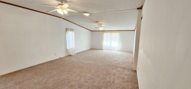 carpeted spare room featuring a textured ceiling, ceiling fan, and crown molding