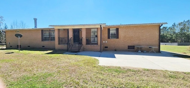 rear view of property featuring a lawn and a patio