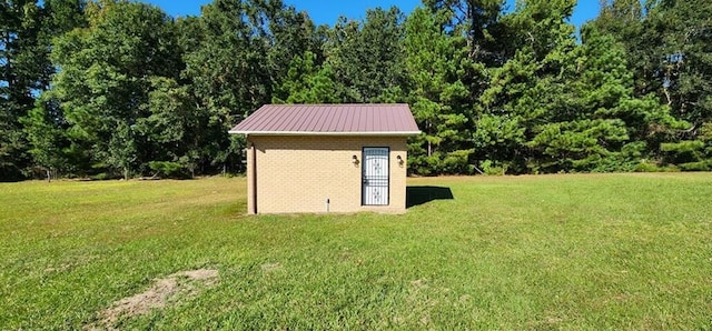 view of outdoor structure featuring a lawn