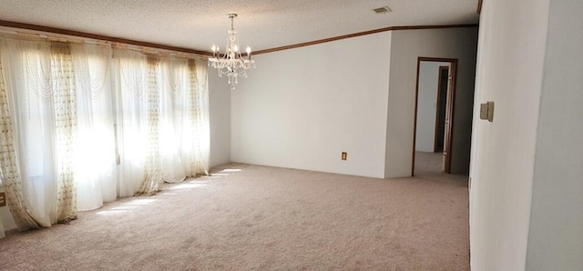 carpeted empty room featuring crown molding, a textured ceiling, and an inviting chandelier