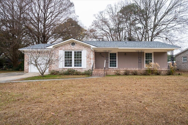 ranch-style home with a garage, a front lawn, and covered porch