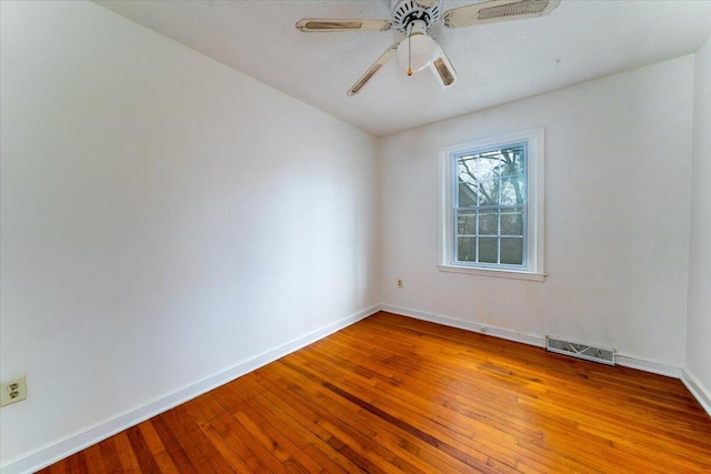 unfurnished room featuring hardwood / wood-style floors and ceiling fan