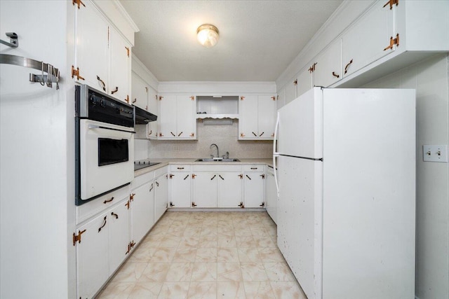 kitchen featuring tasteful backsplash, white appliances, sink, and white cabinets