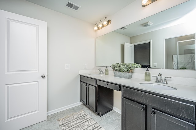 bathroom featuring tile patterned flooring and vanity