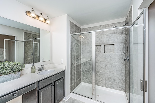 bathroom with vanity and a shower with door