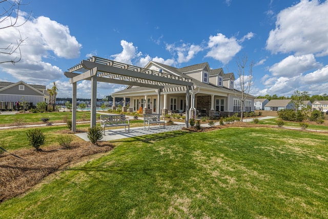 rear view of property featuring a pergola, a patio area, and a lawn