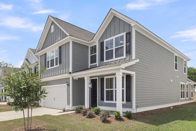 327 Hillman Trl Dr, Moncks Corner, SC 29461 - view of front of home featuring board and batten siding, an attached garage, concrete driveway, and a front lawn