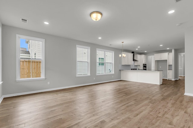 327 Hillman Trl Dr, Moncks Corner, SC 29461 - unfurnished living room featuring baseboards, light wood-style floors, recessed lighting, and a chandelier