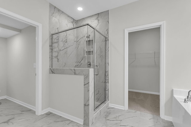 327 Hillman Trl Dr, Moncks Corner, SC 29461 - full bathroom featuring marble look tiles, a garden tub, a marble finish shower, a walk in closet, and baseboards