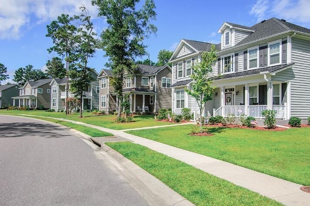327 Hillman Trl Dr, Moncks Corner, SC 29461 - view of front of property featuring a porch, a residential view, a standing seam roof, metal roof, and a front lawn
