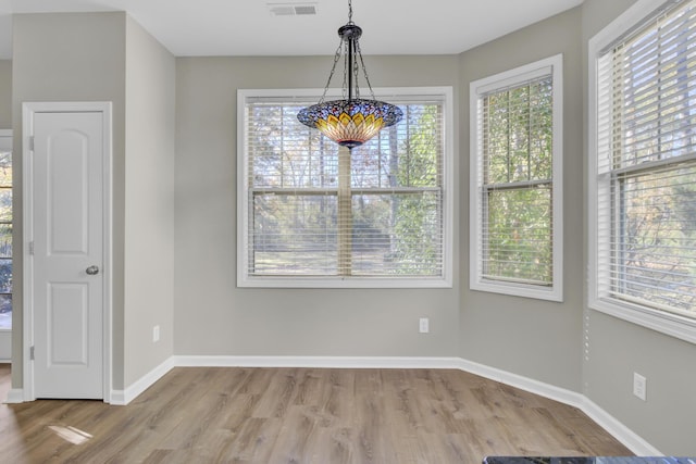 unfurnished dining area with wood-type flooring