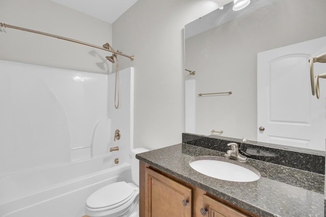 full bathroom with toilet, vanity, and washtub / shower combination