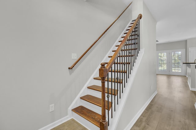 stairway with hardwood / wood-style flooring