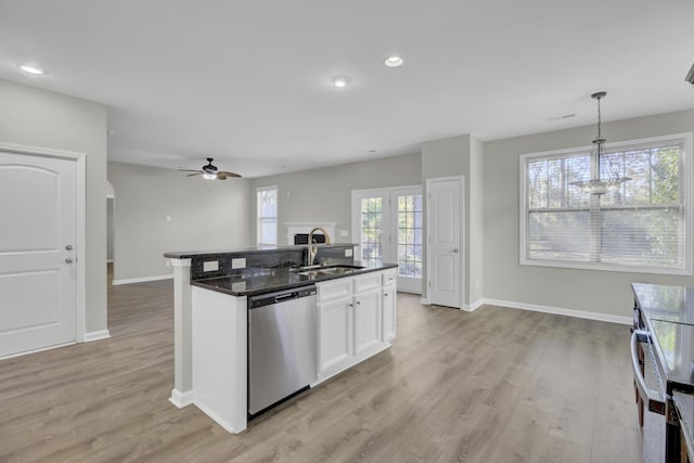 kitchen with white cabinetry, sink, hanging light fixtures, light hardwood / wood-style floors, and appliances with stainless steel finishes