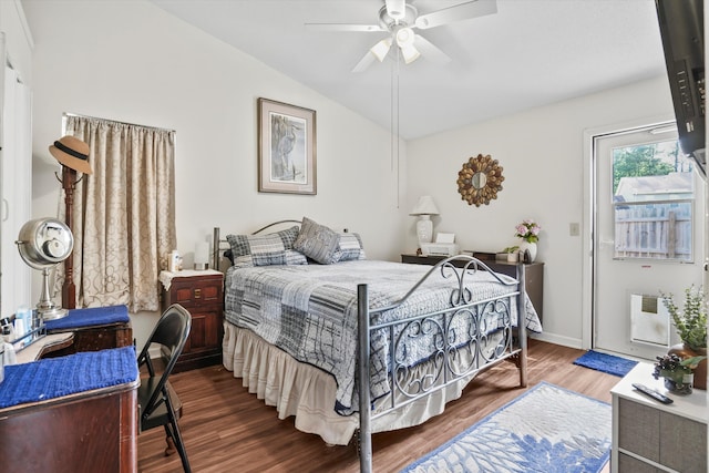 bedroom featuring heating unit, wood finished floors, baseboards, a ceiling fan, and vaulted ceiling