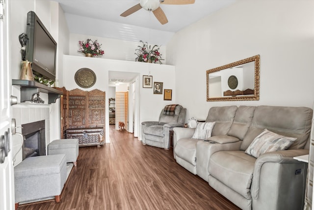 living room with visible vents, a ceiling fan, wood finished floors, and a fireplace