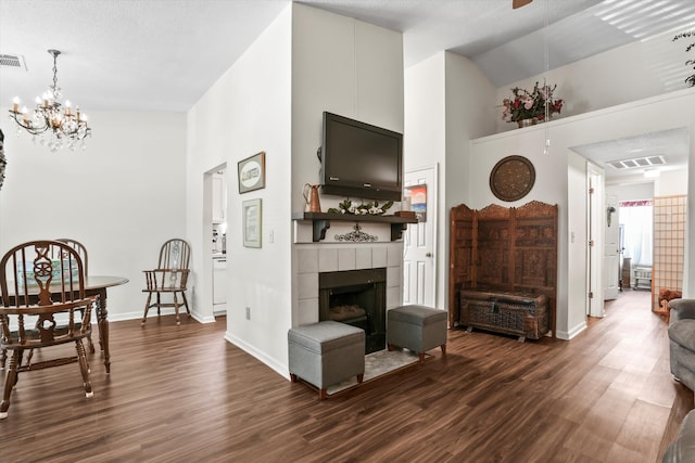 living area featuring high vaulted ceiling, baseboards, and dark wood finished floors