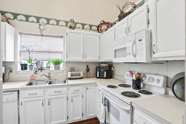 kitchen featuring a sink, light countertops, white cabinets, and white appliances