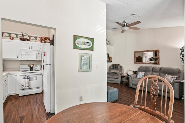 dining space with visible vents, ceiling fan, and dark wood-style floors