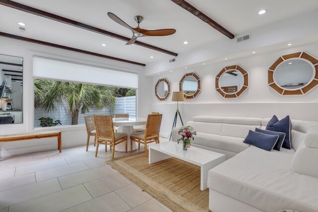 tiled living room featuring beam ceiling and ceiling fan